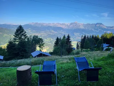 two blue chairs sitting on top of a hill at Chalet d'alpage avec vue incroyable in Saint-Gervais-les-Bains