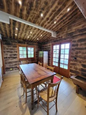 a dining room with a wooden table and chairs at Chalet d'alpage avec vue incroyable in Saint-Gervais-les-Bains