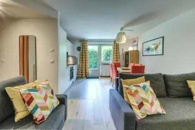 a living room with two couches and a kitchen at Apartment Picasso in Chamonix-Mont-Blanc
