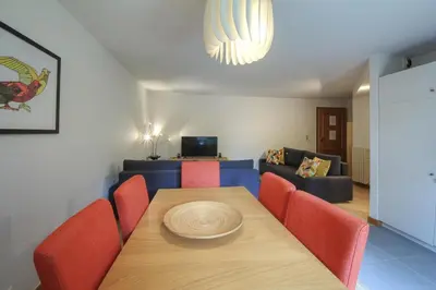 a dining room with a table and red chairs at Apartment Picasso in Chamonix-Mont-Blanc