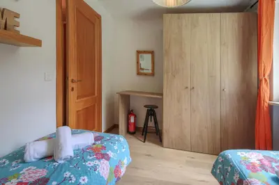 a bedroom with a bed and a wooden cabinet at Apartment Picasso in Chamonix-Mont-Blanc
