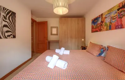 a bedroom with a bed with towels on it at Apartment Picasso in Chamonix-Mont-Blanc