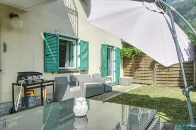 a patio with a table and an umbrella at Apartment Picasso in Chamonix-Mont-Blanc