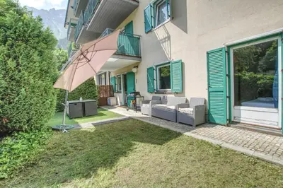a patio with an umbrella next to a building at Apartment Picasso in Chamonix-Mont-Blanc