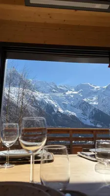 a bedroom with a white bed and a window at Chalet Soljanel in Chamonix-Mont-Blanc