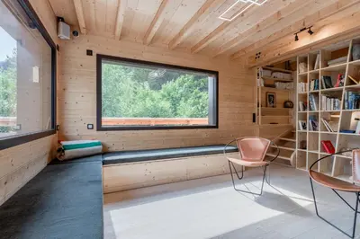 a room with a window and a bench and chairs at Chalet Soljanel in Chamonix-Mont-Blanc