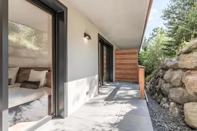 a room with a window and a stone wall at Alpage Mont Blanc in Combloux