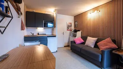 a living room with a couch and a kitchen at P LES ESSERTS - 51 - Studio 4 pers in Morillon