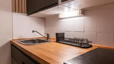 a kitchen with a sink and a counter top at P LES ESSERTS - 51 - Studio 4 pers in Morillon