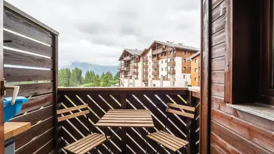 a balcony with two chairs and a table at P LES ESSERTS - 51 - Studio 4 pers in Morillon