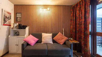 a living room with a couch with pillows on it at P LES ESSERTS - 51 - Studio 4 pers in Morillon