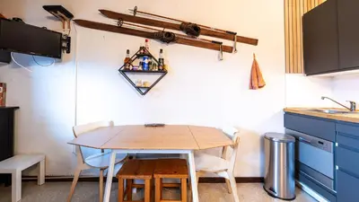 a small kitchen with a wooden table and chairs at P LES ESSERTS - 51 - Studio 4 pers in Morillon