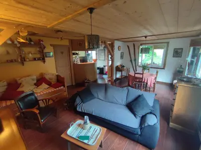 a living room with a blue couch and a table at Le Refuge des Trolls in Sixt
