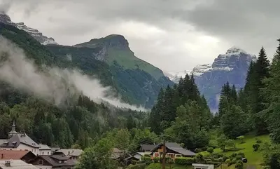 a village in a valley with mountains in the background at Le Refuge des Trolls in Sixt