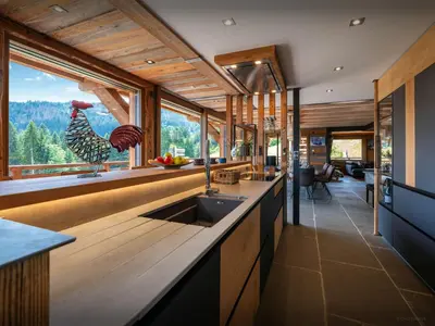 a living room with a pool table and a large window at Chalet K1027 - OVO Network in Cordon
