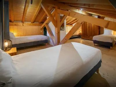 a bedroom with two beds in a attic at Chalet Nahuel Huapi - OVO Network in Samoëns