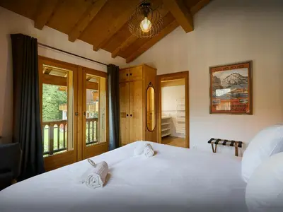 a bedroom with two white beds and a window at Chalet Nahuel Huapi - OVO Network in Samoëns