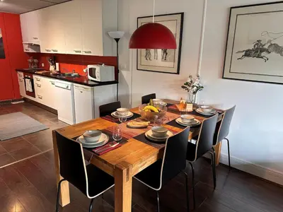 a dining room with a wooden table and chairs at Confortable appartement 3 pièces · Proche des pistes · WIFI · 6 pers - FR-1-425-225 in Arâches-la-Frasse