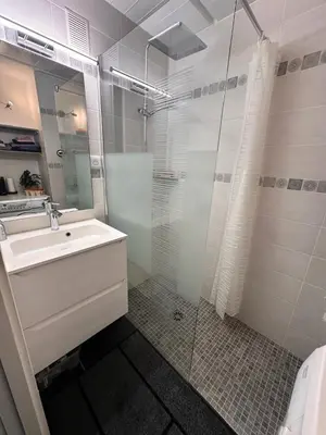 a bathroom with a sink and a glass shower at Résidence Cassiopee - Appartement tout confort · proche des pistes · WIFI gratuit · vue pistes MAE-0471 in Magland