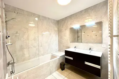 a bathroom with a tub and a sink and a shower at Clair des Prés in Saint-Gervais-les-Bains