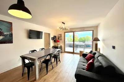 a living room with a table and a couch at Clair des Prés in Saint-Gervais-les-Bains