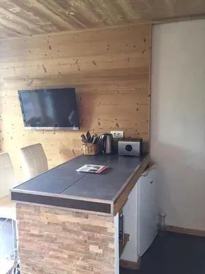 a kitchen with a sink and a washing machine at Scoot 4 étoiles in Demi-Quartier
