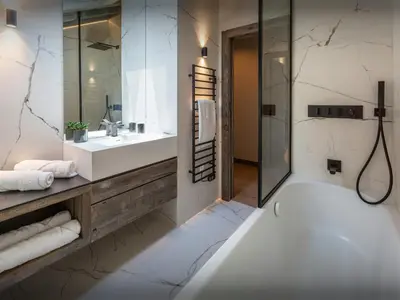 a bathroom with a white tub and a sink at Chalet Mussol - OVO Network in Saint-Gervais-les-Bains