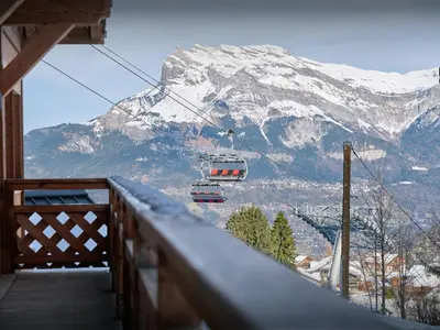 a gondola on a ski lift in front of a mountain at Chalet Mussol - OVO Network in Saint-Gervais-les-Bains