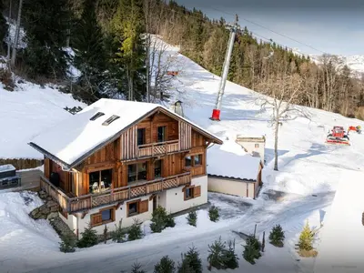 a wooden house in the snow with a ski lift at Chalet Mussol - OVO Network in Saint-Gervais-les-Bains