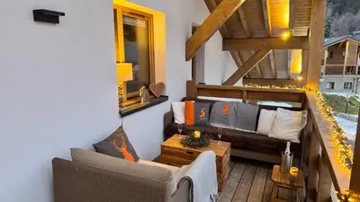 a living room with a couch and a table at Flocons de Megève in Megève