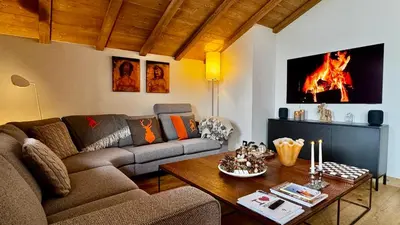 a living room with a couch and a table at Flocons de Megève in Megève