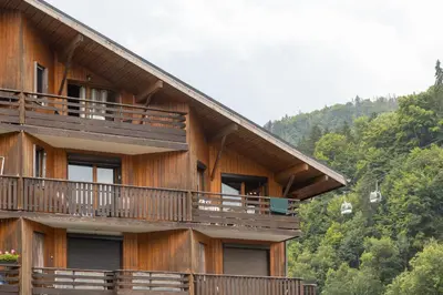 a building with balconies on the side of it at Charmant appartement avec balcon et commodités modernes in Samoëns