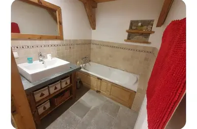 a bathroom with a sink and a bath tub at Chalet Combe in Samoëns