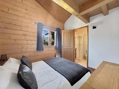 a bedroom with a bed in a wooden room at CRIS112 - Duplex 8 personnes centre village in Les Carroz d'Araches