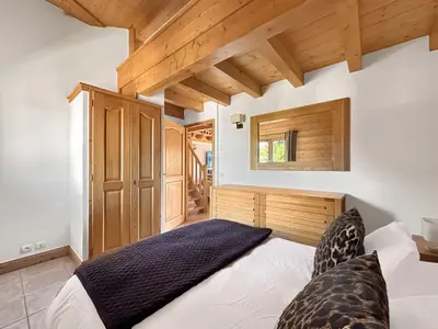 a bedroom with a bed and a wooden ceiling at CRIS112 - Duplex 8 personnes centre village in Les Carroz d'Araches