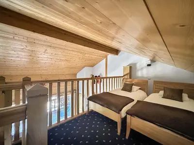 a room with two beds on a balcony at CRIS112 - Duplex 8 personnes centre village in Les Carroz d'Araches