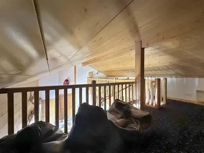 a room with a couch in the middle of a building at CRIS112 - Duplex 8 personnes centre village in Les Carroz d'Araches
