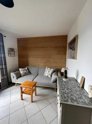 a living room with a couch and a table at Appartement centre Saint Gervais-Vue imprenable in Saint-Gervais-les-Bains