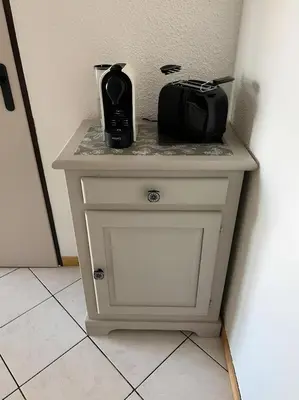 a small white table with a toaster and a appliance on it at Appartement centre Saint Gervais-Vue imprenable in Saint-Gervais-les-Bains