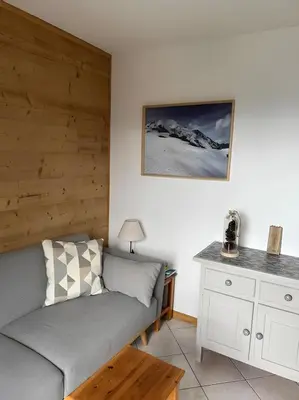 a living room with a couch and a table at Appartement centre Saint Gervais-Vue imprenable in Saint-Gervais-les-Bains