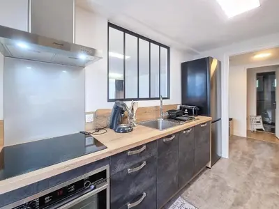 a kitchen with a sink and a counter top at Appartement 3 pièces avec balcon et parking à Combloux - FR-1-560-146 in Combloux