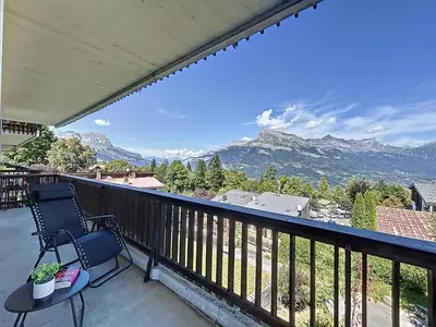 a balcony with two chairs and a view of mountains at Appartement 3 pièces avec balcon et parking à Combloux - FR-1-560-146 in Combloux