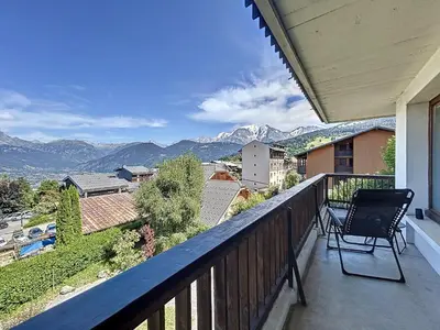 a balcony with a chair and a view of mountains at Appartement 3 pièces avec balcon et parking à Combloux - FR-1-560-146 in Combloux