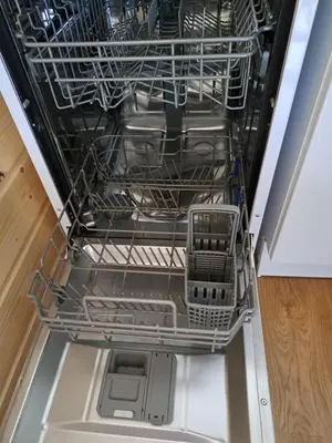 an empty dishwasher with its dishes in it at T3 avec vue montagne in Les Contamines-Montjoie
