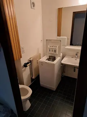 a small bathroom with a toilet and a sink at T3 avec vue montagne in Les Contamines-Montjoie