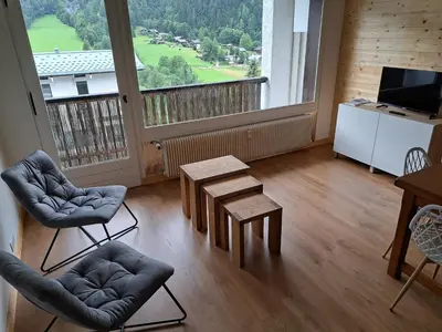 a room with two chairs and a table and a large window at T3 avec vue montagne in Les Contamines-Montjoie
