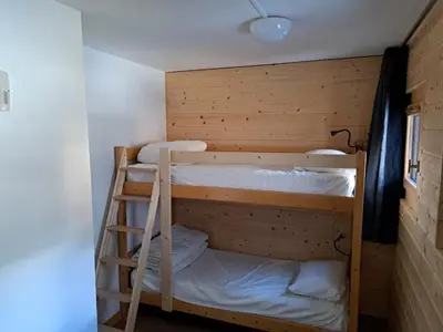 a bunk bed room with two bunk beds and a ladder at T3 avec vue montagne in Les Contamines-Montjoie