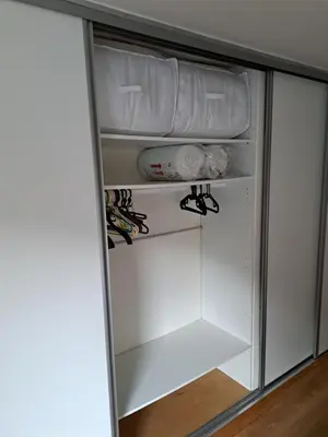a white closet with white shelves in a room at T3 avec vue montagne in Les Contamines-Montjoie