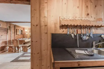 a kitchen with wooden walls and a counter with utensils at Le Gite - Le Mont d'Arbois - 5 pax in Saint-Gervais-les-Bains