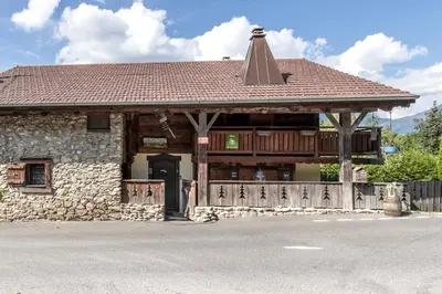 a stone building with a porch and a roof at Le Gite - Le Mont d'Arbois - 5 pax in Saint-Gervais-les-Bains